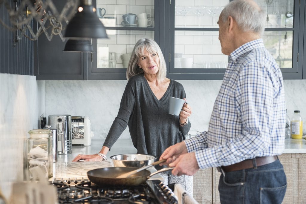 Couple discussing equity release in their kitchen