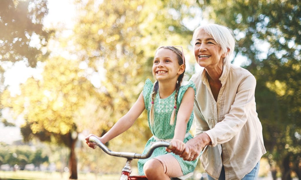 grandmother enjoying retirement cycling with child after releasing equity from her home