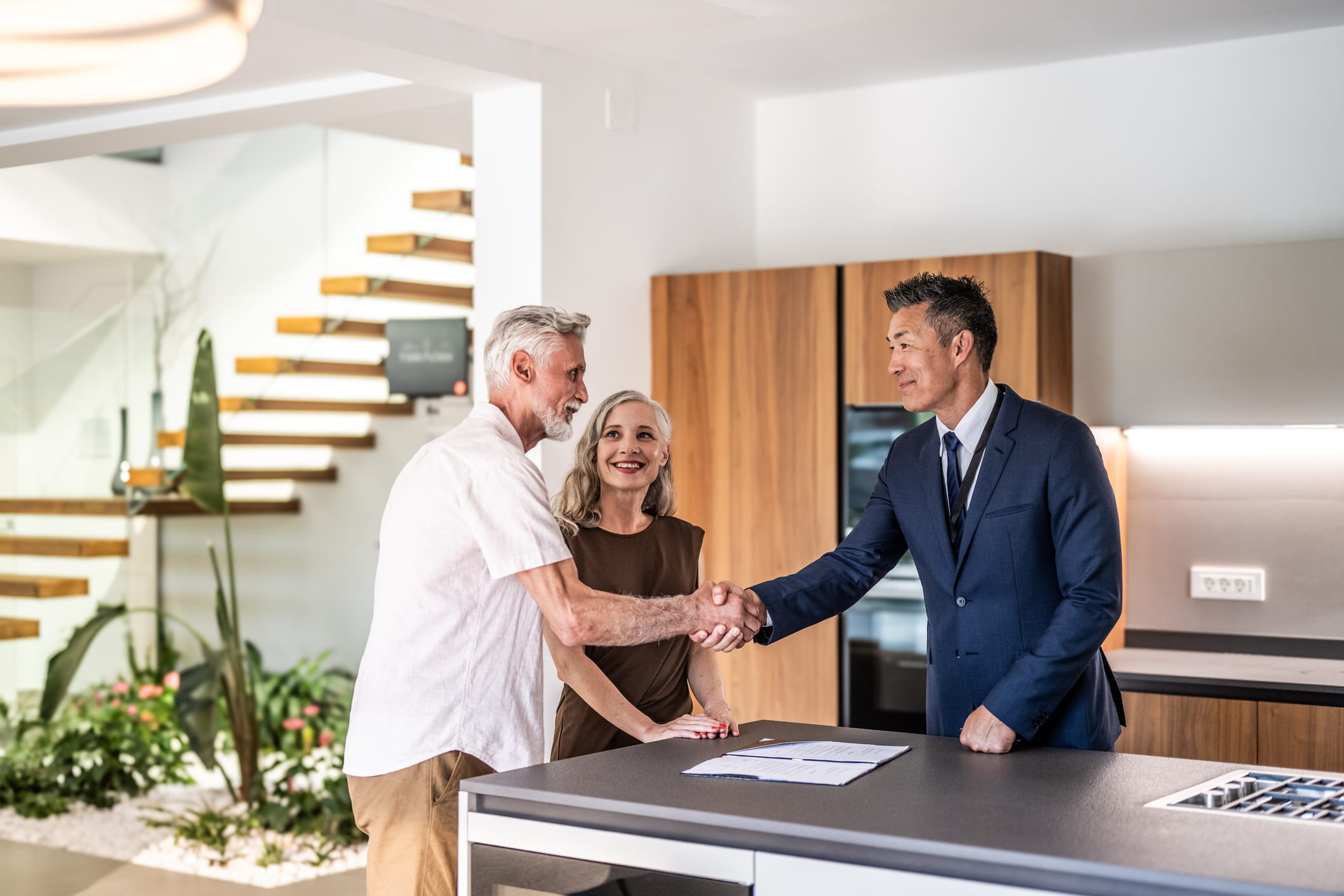 Couple completing on their new home following mortgage advice