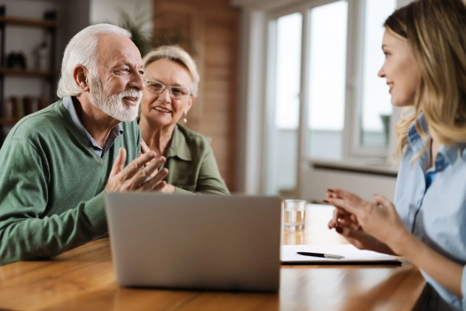 Couple having a discussion with an equity release adviser in their home