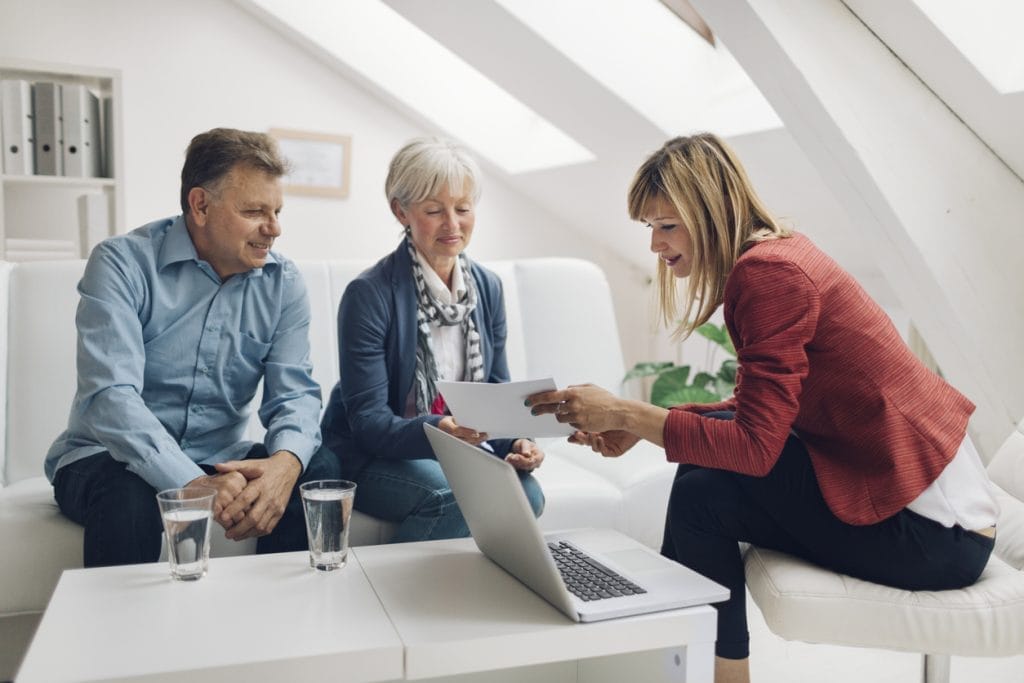 couple speaking to equity release adviser about lump sum lifetime mortgages